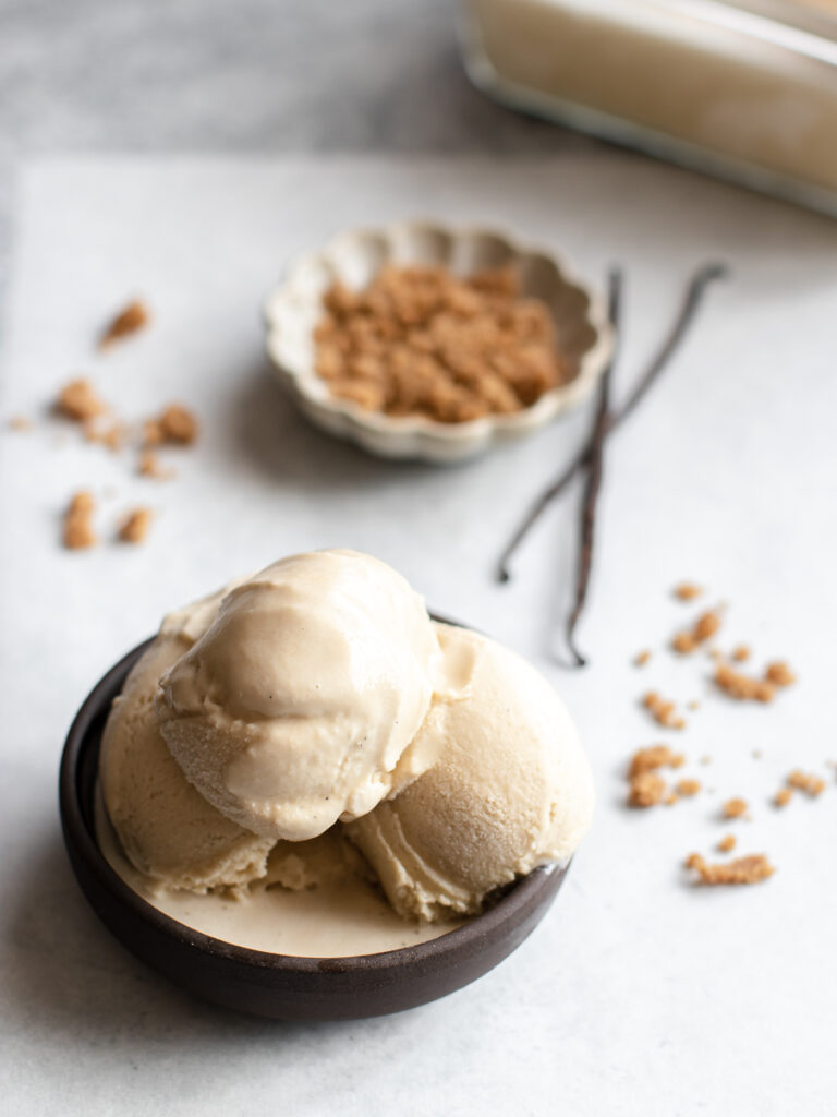 Bowl of frozen custard made with brown sugar and vanilla beans.