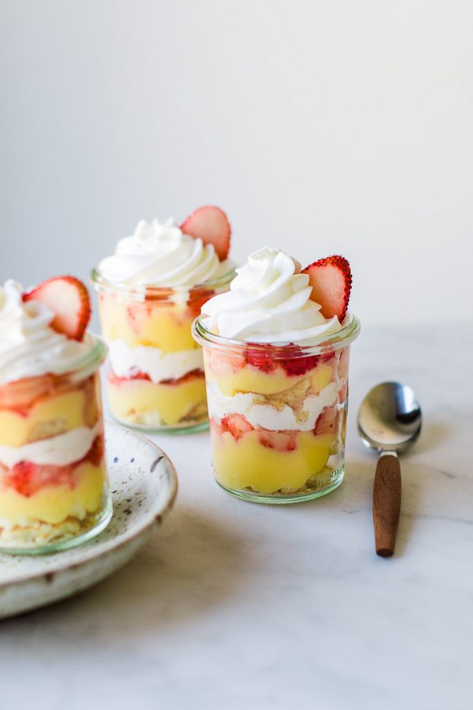 Lemon Strawberry trifle parfait jars with spoon.