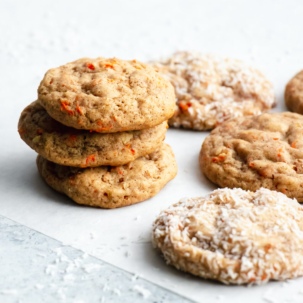 Carrot cake cookie stack with a few coated in shredded coconut for texture and beauty.