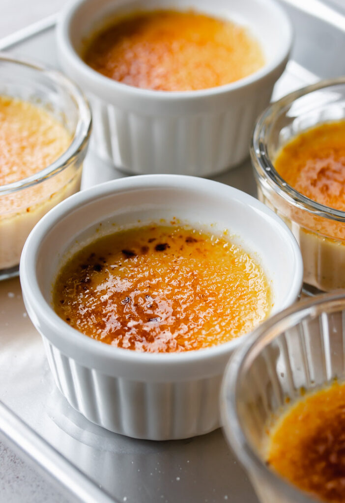 Sugary glass top on vanilla creme brulee ramekins.