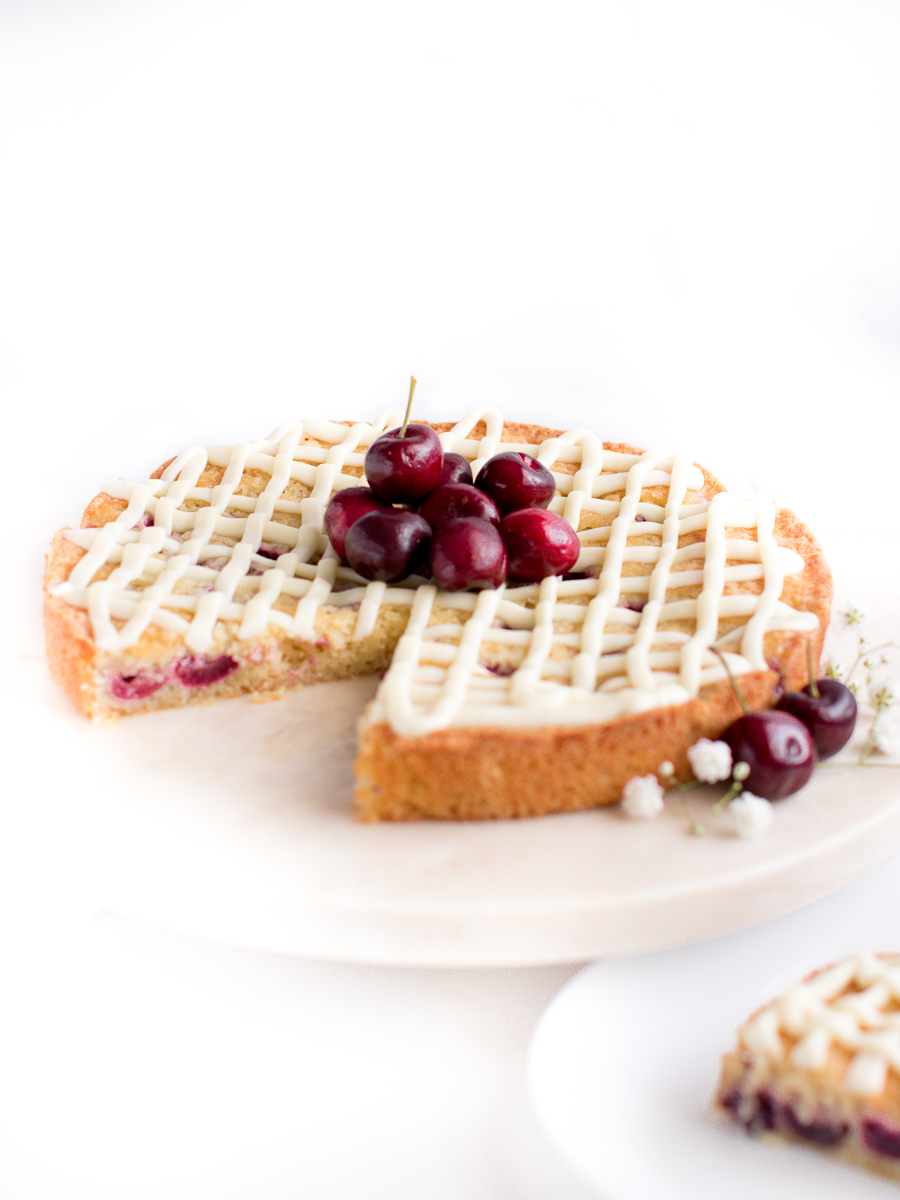 Gorgeous almond cherry cake resembles a cherry pie with fresh cherries on top.