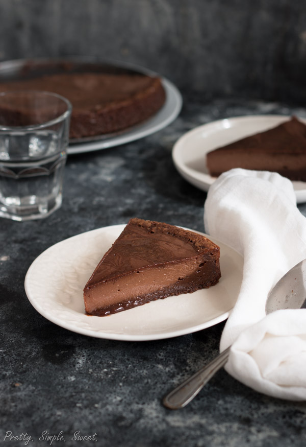 Brownie cheesecake with visible brownie layer with chocolate cheesecake layer slice.