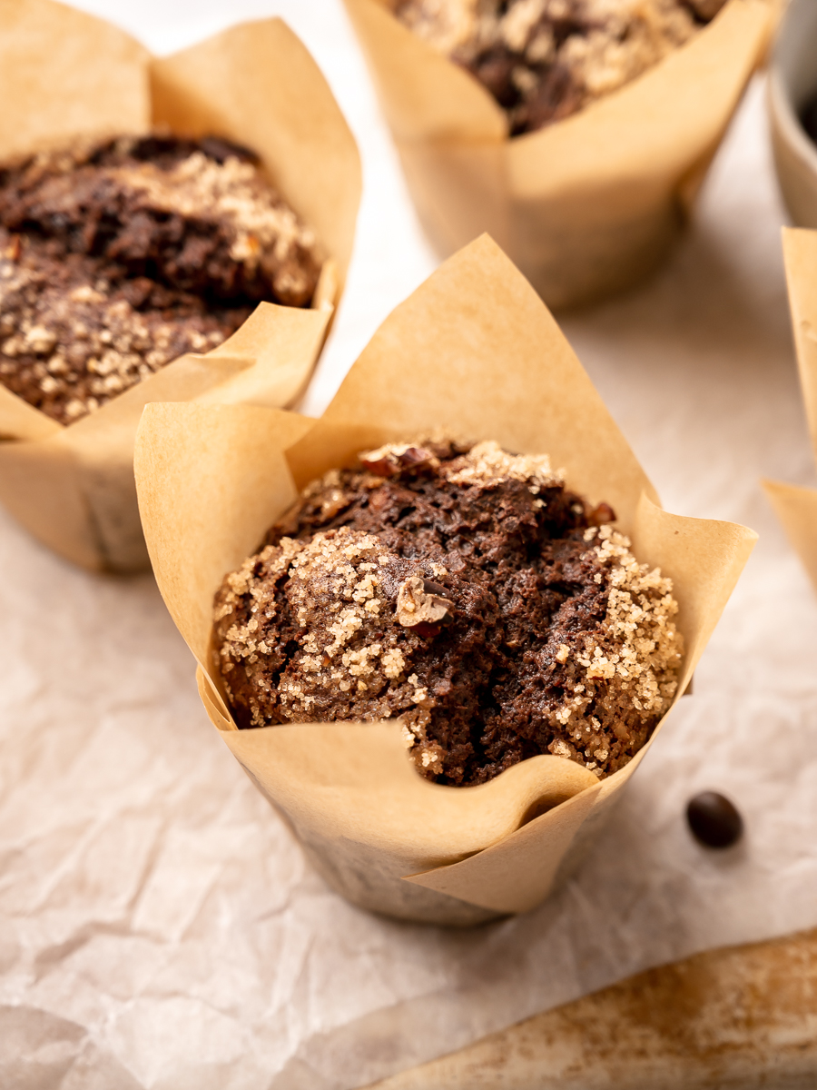 Delicious chocolate muffins with crunchy sugar and nut toppings.