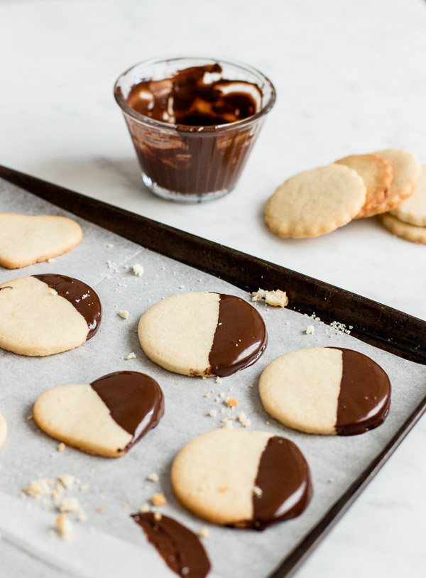 Chocolate Dipped Shortbread Cookies drying on a parchment paper.