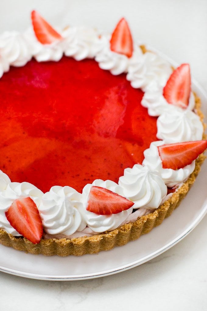 Easy and simple to make white chocolate mousse tart topped with strawberry jam glaze. No baking involved! 