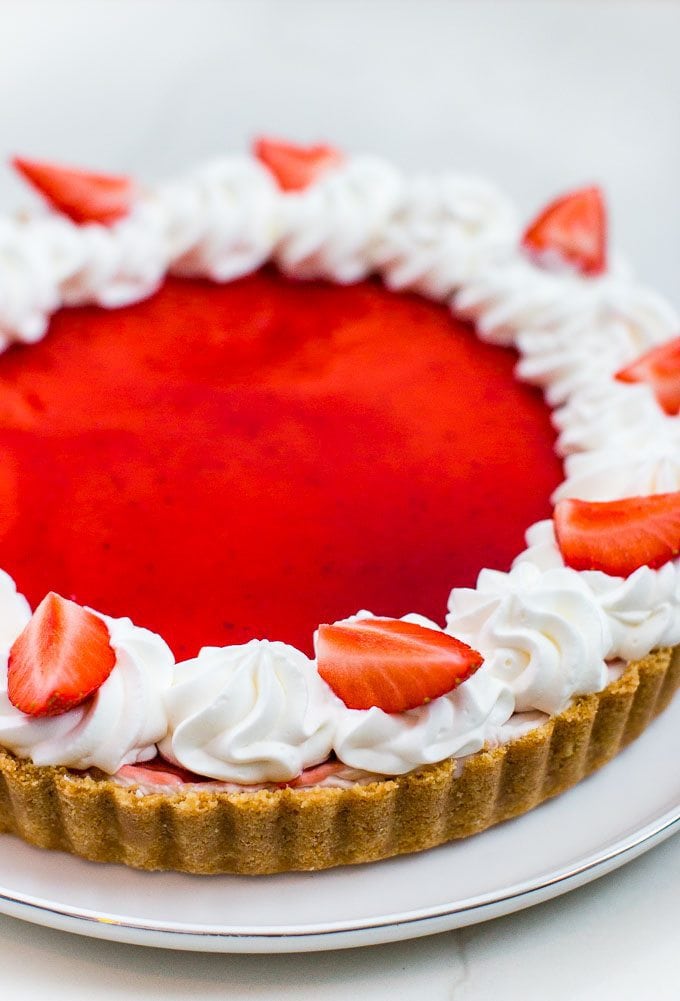 Easy and impressive no-bake strawberry and white chocolate tart with a simple cookie crust. This pie is perfect for Valentine's Day!