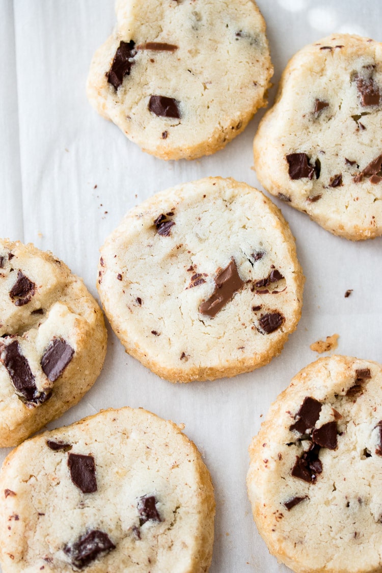 Chocolate Chip Shortbread Cookie slices baked on a parchment lined cookie sheet.