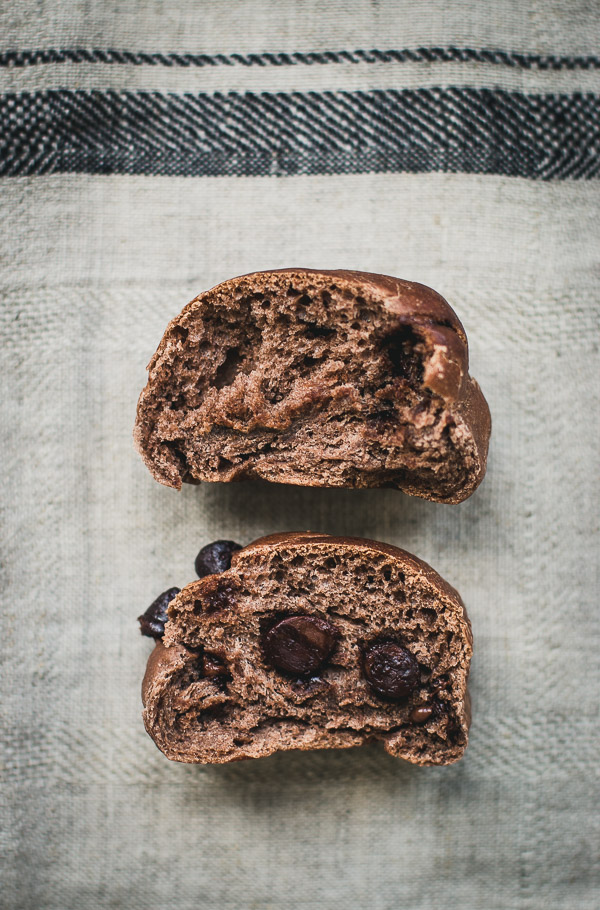 Chocolate Bun pulled apart to reveal morsels of gooey chocolate inside.