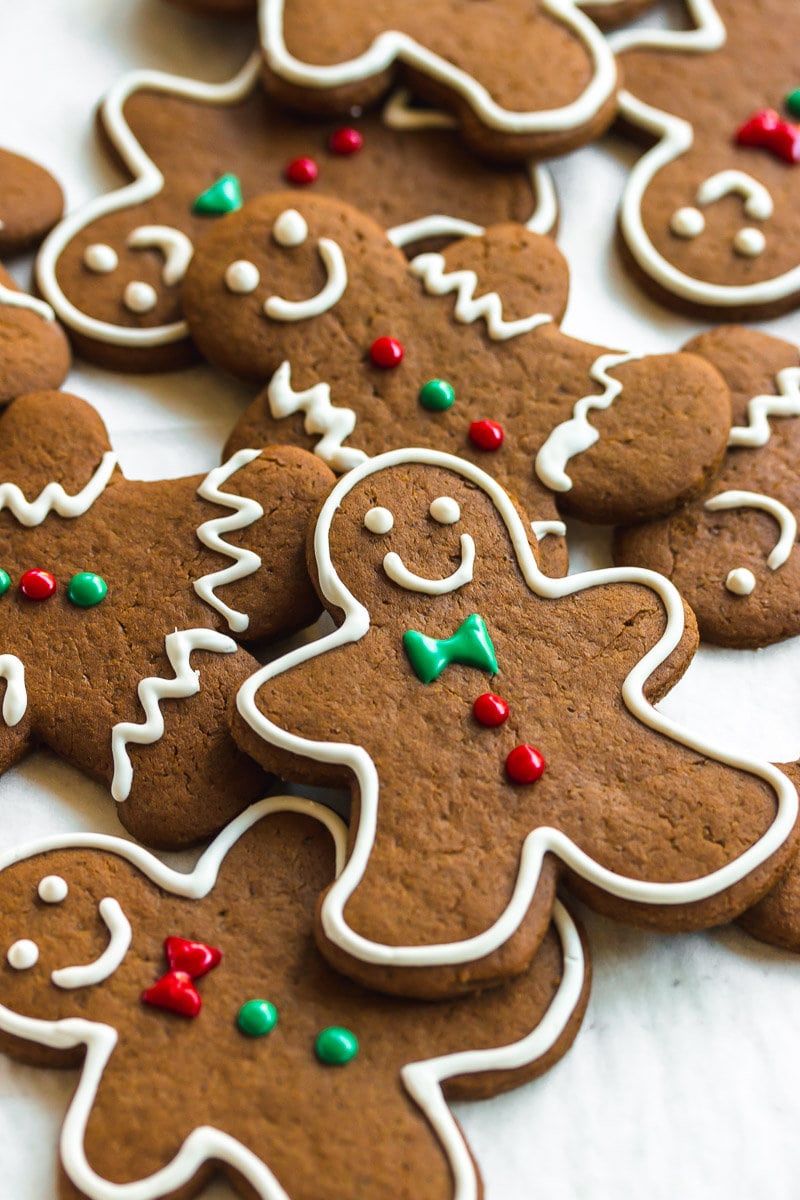 The perfect gingerbread cookies decorated with red, green, and white royal icing.