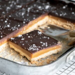 Salted caramel shortbread bars in a pan.