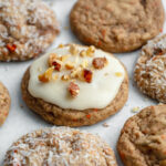 A variety of easy carrot cake cookies topped with cream cheese frosting and walnuts, plain, or coated in coconut.