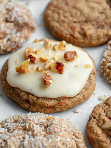 A variety of easy carrot cake cookies topped with cream cheese frosting and walnuts, plain, or coated in coconut.