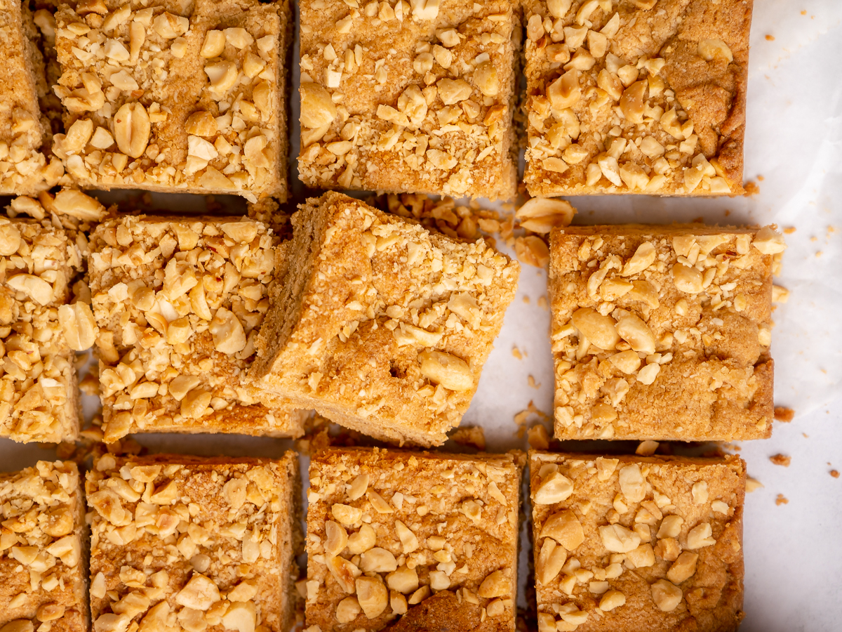 Overhead view of peanut butter blondie bars with visible peanuts on top.