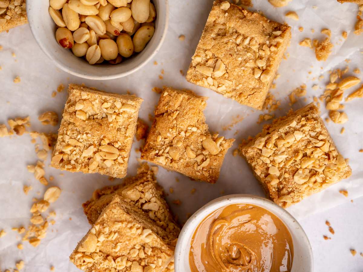 Peanut butter and chewy peanut butter blondie bars with a bite taken out of one.