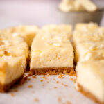 White chocolate cheesecake bars with lemon zest and juice.