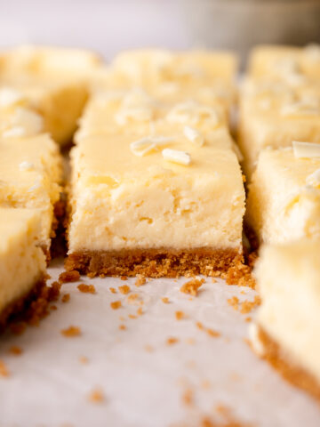 White chocolate cheesecake bars with lemon zest and juice.