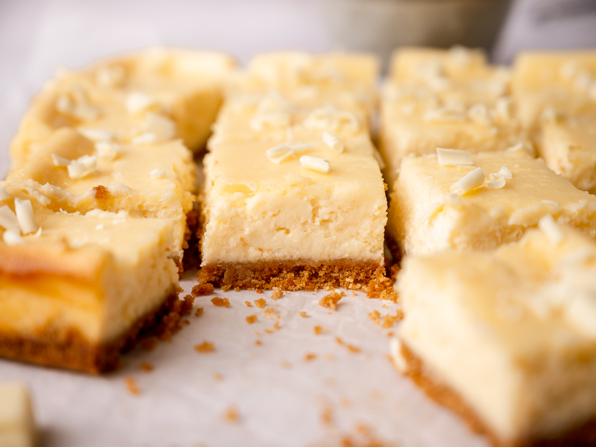 White chocolate cheesecake bars with lemon zest and juice.