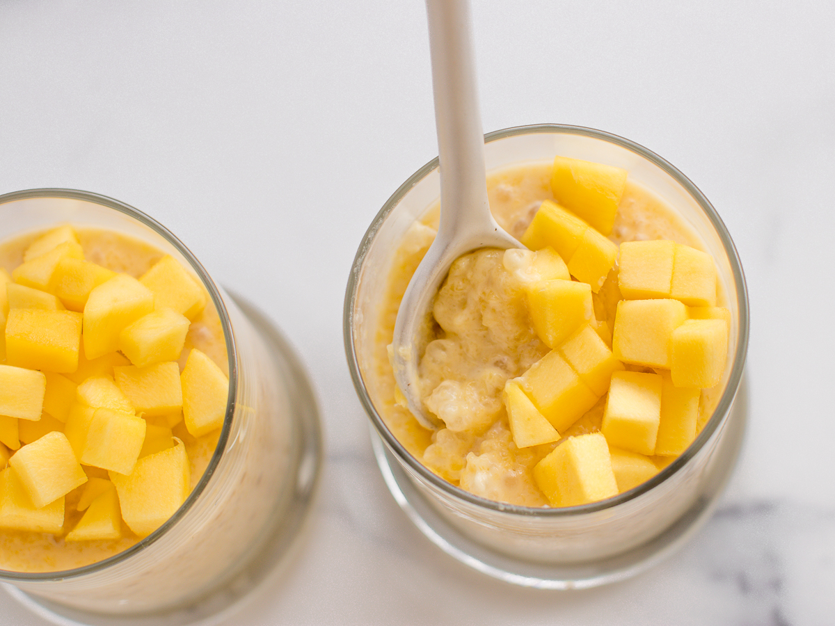 Spoonful of mango sago pudding showing how thick the consistency is.