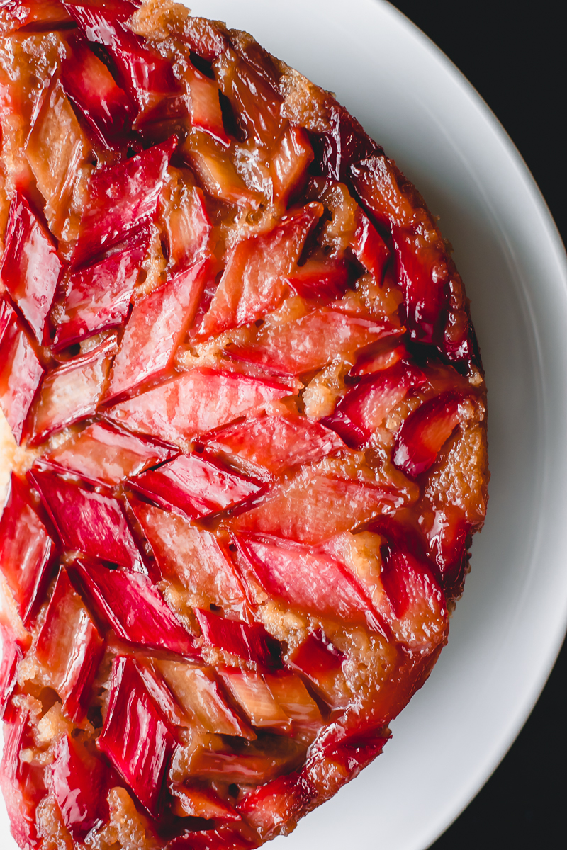 Rhubarb upside down cake with caramelized rhubarb glistening on top.