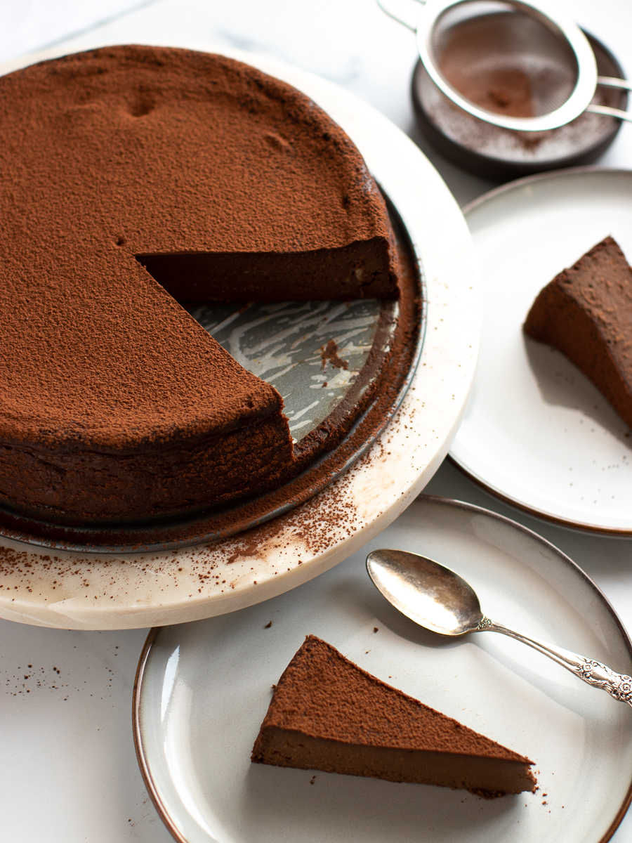 Top Gluten-free chocolate pumpkin torte with a dusting of cocoa powder.