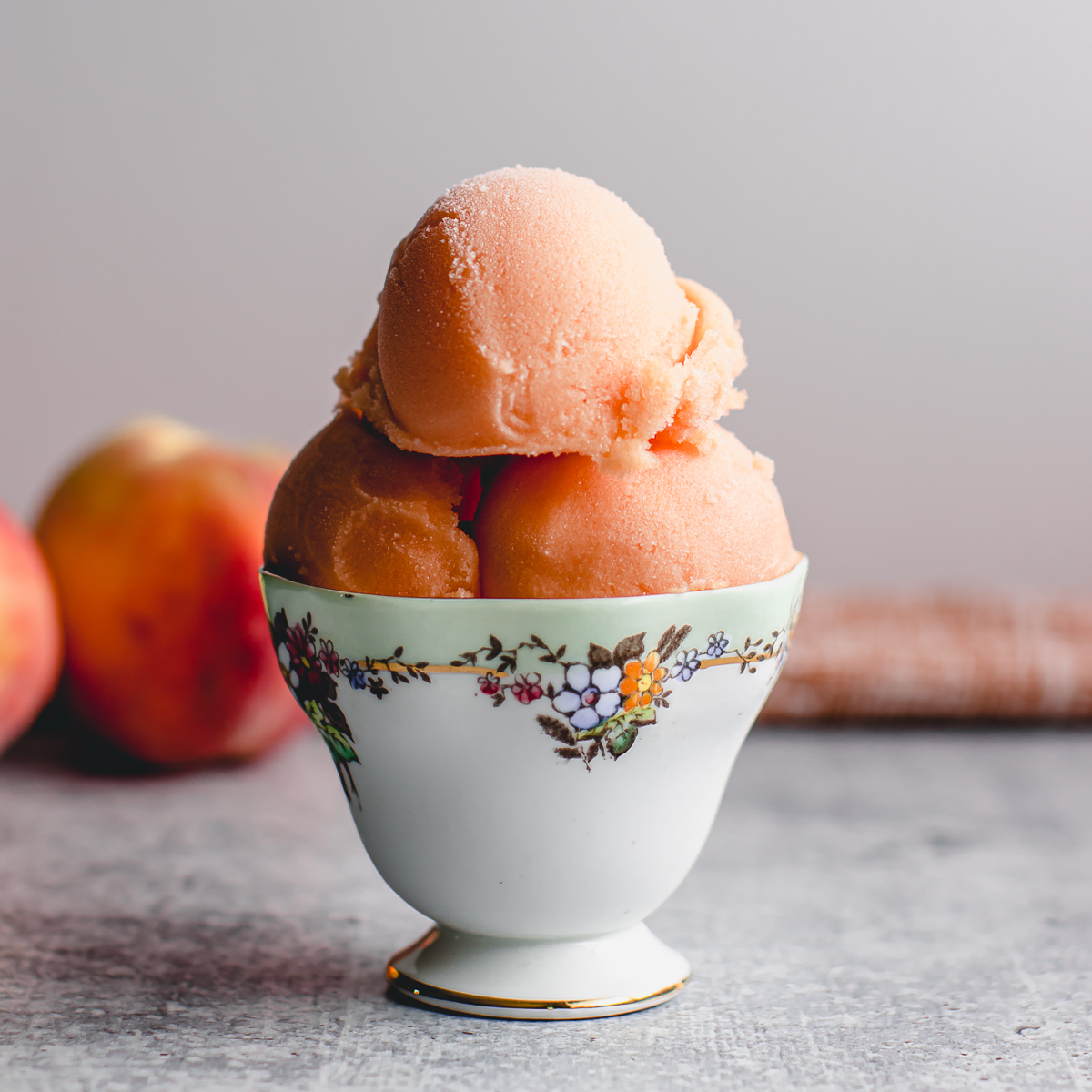 Scoops of peach sorbet made without an ice cream maker and only 4 ingredients.