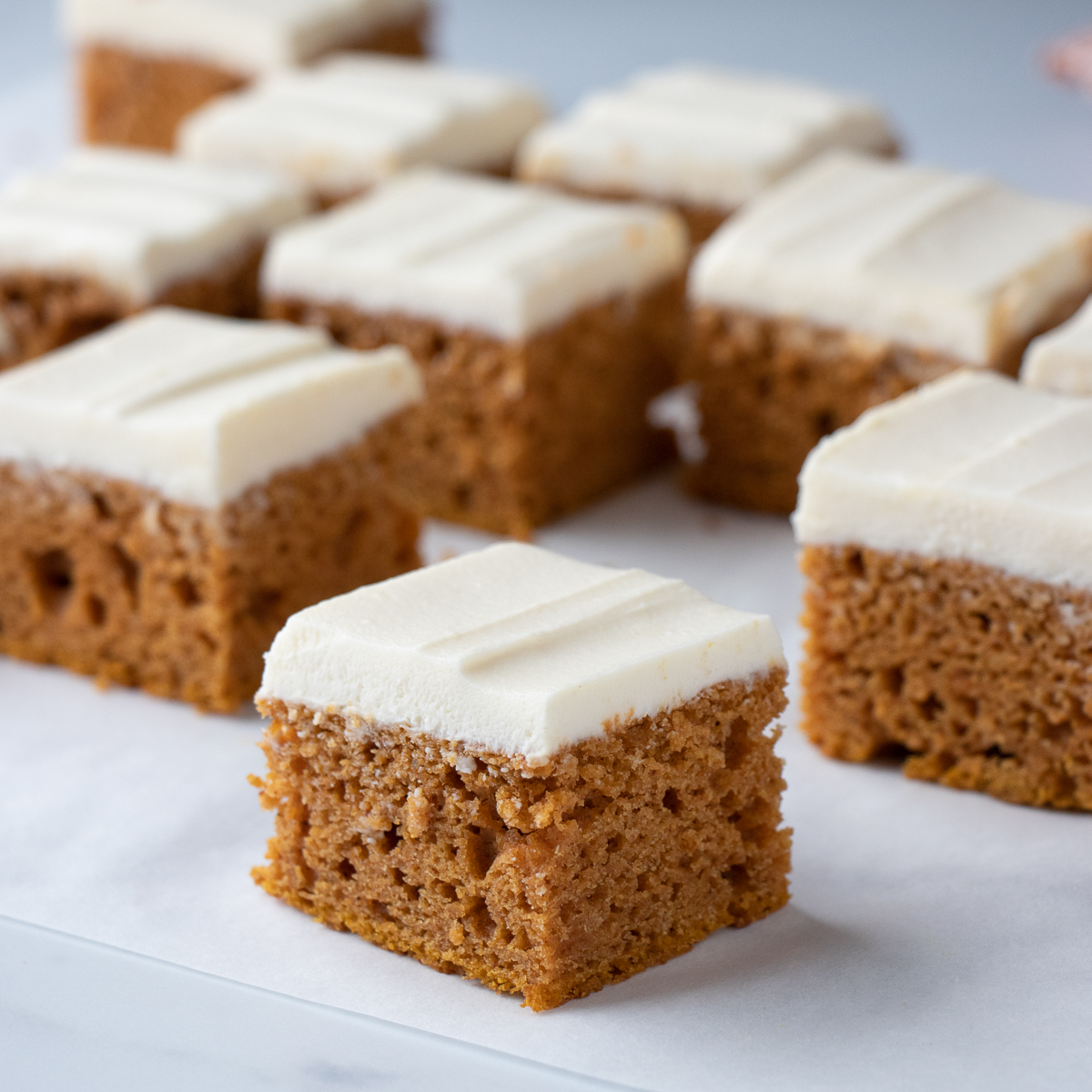 Pumpkin Bar squares with thick layer of buttery cream cheese frosting.