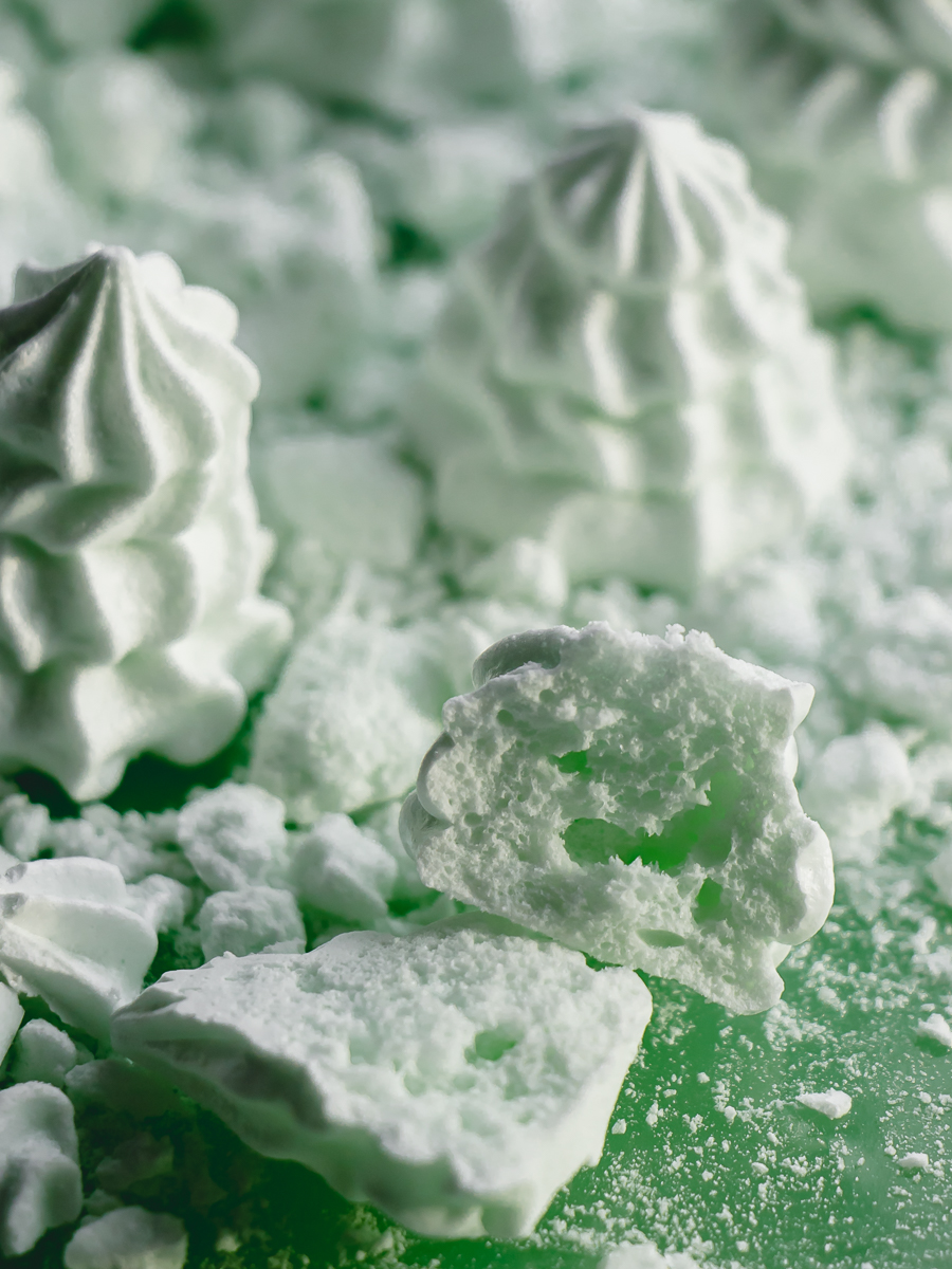 Mint meringue cookies shaped like Christmas trees - cut in half to reveal the center.